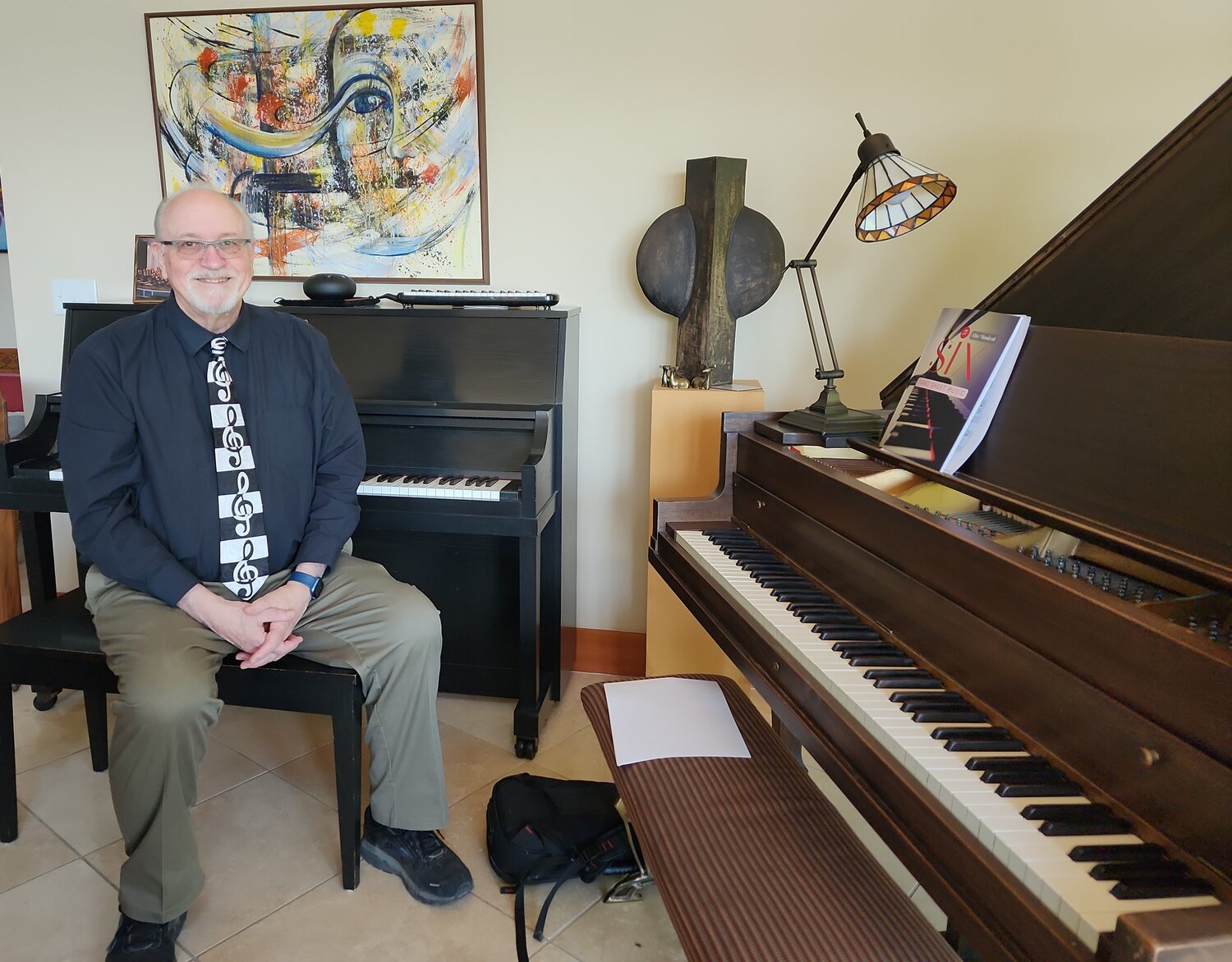 Gary Witley at home, sitting at his piano, June 6, 2023.
